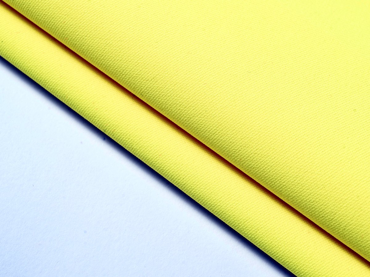 High-visibility yellow fabric detail for workwear sourcing
